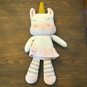 Kenzie unicorn living textiles plush toy. Knitted stuffed animal with rattle.